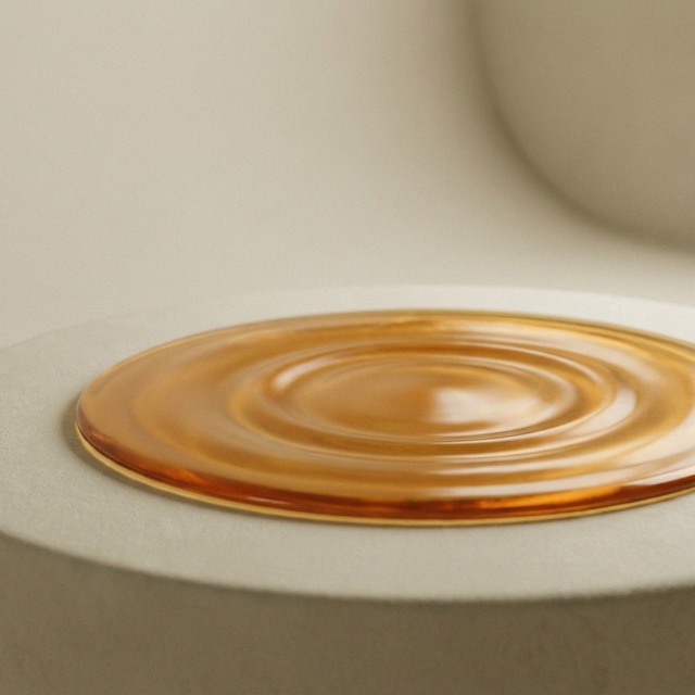 Soft ripple rings expanding across an amber-gold surface